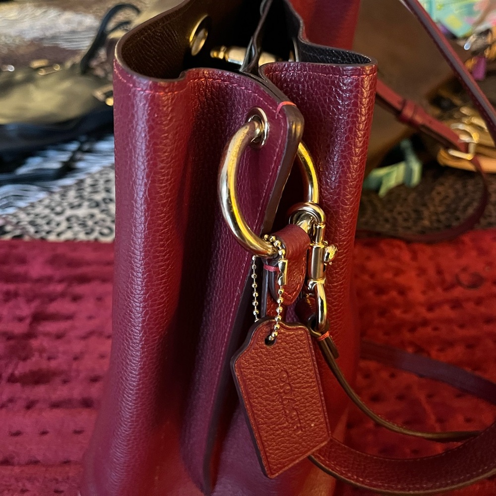Burgundy or dark red Coach bag